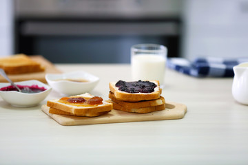 Toaster with dishes and sandwiches on a light kitchen table