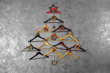 Christmas tree of hangers on a dark grey wall