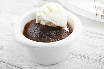 Chocolate lava cake with ice-cream in a bowl, close-up