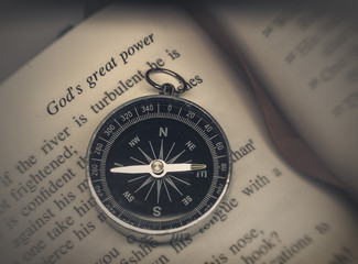 Bible on compass - religion faith concept image © BCFC