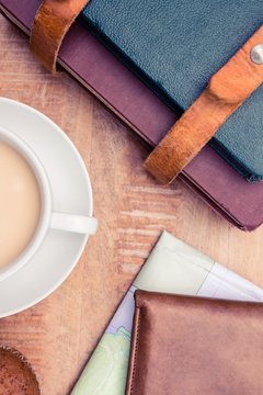 Close-up of coffee with wallet and diaries