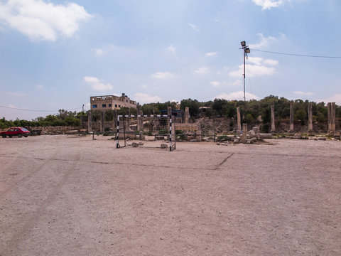 Football field and parking in close proximity to the ruins of an
