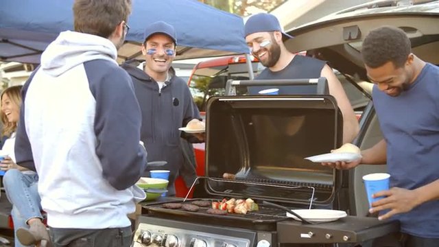 Slow Motion Shot Of Sports Fans Tailgating In Parking Lot