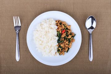 Rice topped with stir-fried chicken and  basil, fried stir basil with minced chicken on white background (Isolated Background)