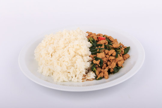 Rice topped with stir-fried chicken and  basil, fried stir basil with minced chicken on white background (Isolated Background)