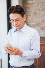 Serious man using smartphone