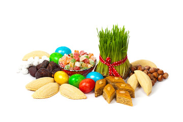 Novruz in Azerbaijan. Colored eggs for Easter and traditional sweets. Selective focus.