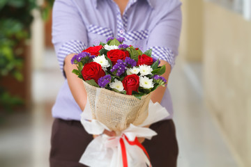 Woman holding a bouquet of roses in hand for Valentine's Day