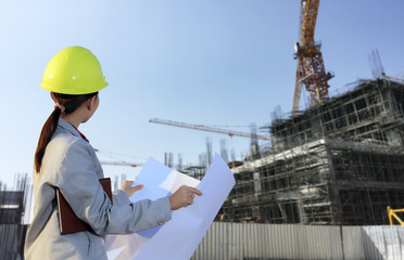portrait women asia engineer working and holding blueprints at c