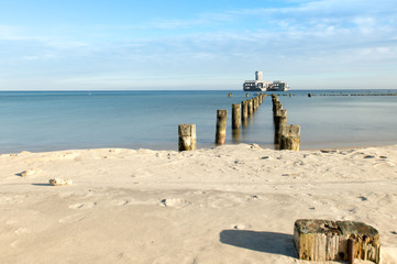 Obraz premium Beach in Gdynia at Baltic sea with view on ruins of torpedo from second world`s war.