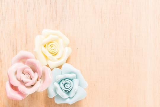 Closeup Pastel Rose (Ceramic ) on wooden background