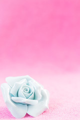 Pastel Rose (Ceramic ) on pink fabic background