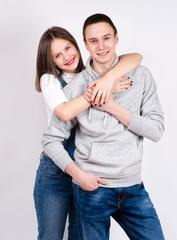 Portrait of happy couple isolated on white background. Attractive man and woman being playful.