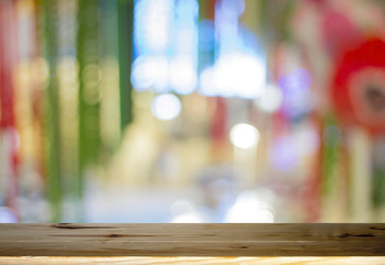 Wood table top on shiny bokeh colorful and gold background