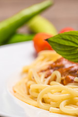 plate of Italian spaghetti with fresh tomato served with a leafy