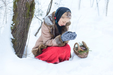 Fototapeta na wymiar Sad woman in snowy forest