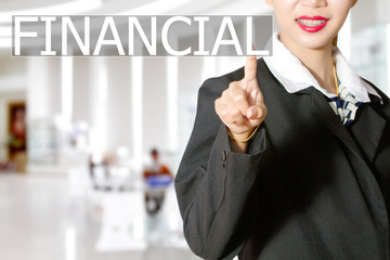 Businesswomen hand touching FINANCIAL sign on virtual screen on