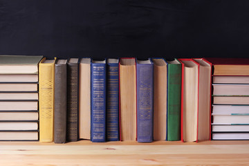 Books on the shelf on a black background.