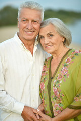 Happy senior couple  near river