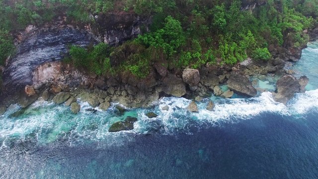 Etretat Aval cliff, rocks and natural arch landmark and blue ocean. Aerial view. Indonesia, Bali.