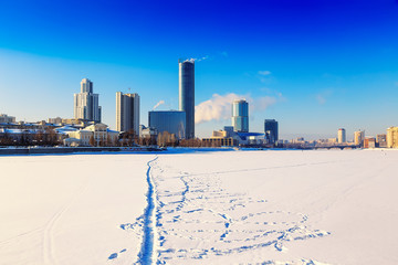 View of quay wharf embankment Yekaterinburg City. Winter. Sun