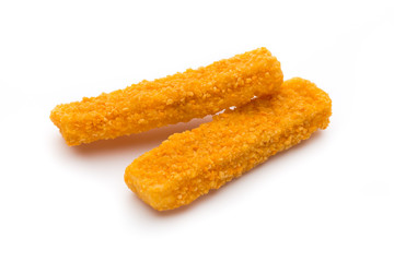 Frozen bread crumbed fish fingers on white.