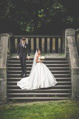 elegant stylish young couple beautiful bride and groom on the stairs