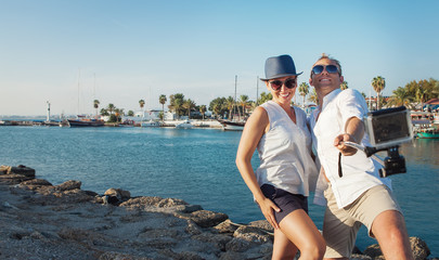 Funny couple take vacation selfie on the sea bay