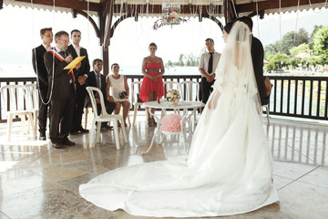 Happy handsome groom and beautiful bride in white dress in weddi