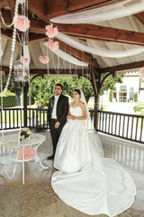 Happy handsome groom and beautiful bride in white dress in weddi