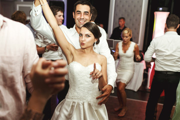 Romantic married couple bride and groom dancing at wedding recep