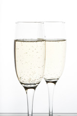 two glasses of champagne on white background