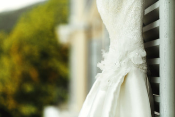 Gorgeous elegant stylish vintage white dress on window outdoors