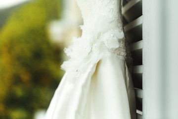 Gorgeous elegant stylish vintage white dress on window outdoors