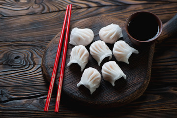 Chinese dim sum dumplings in a rustic wooden setting, closeup