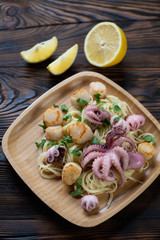Bamboo tray with spaghetti and seafood, high angle view