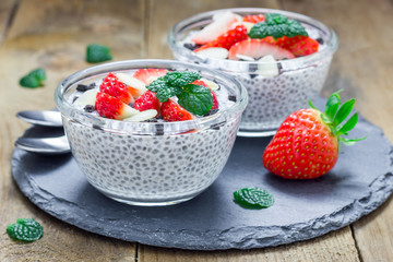 Chia seed pudding with strawberries, almond and chocolate cookie crumbs