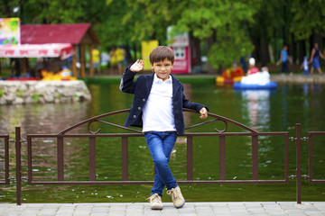 Full-length portrait of a little boy in the summer park