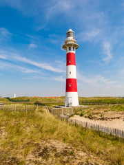 Fototapeta na wymiar Lighthouse on the coast of the North Sea in a sunny day, Belgium