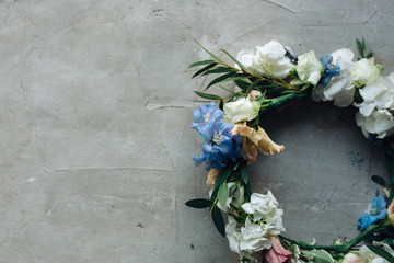 Spring flower wreath making on gray, top view