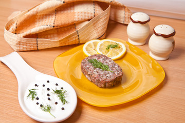 raw cutlets with lemon slices on a cutting board