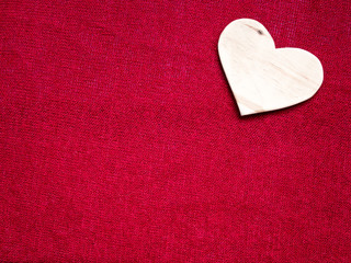 Wood heart on a red fabric
