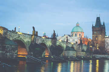 Fototapeta premium The Charles Bridge (Czech: Karluv Most) is a famous historic bridge that crosses the Vltava river in Prague, Czech Republic. Vintage filter applied.