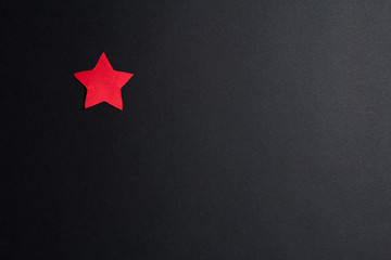 Fototapeta na wymiar Red paper star on a black background