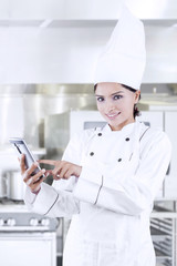 Chef searching menu with cellphone