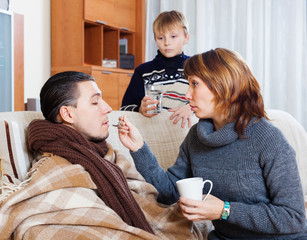 Sick man surrounded by caring wife and  son