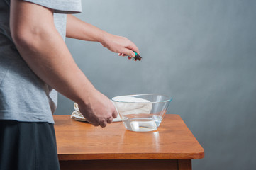 inhalation / The man doing inhalation above bowl on a table at home.