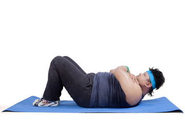 Overweight man exercising in studio