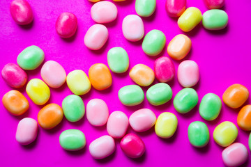 Colorful candy on pink background