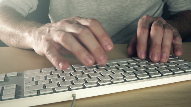 Man typing computer keys, time lapse footage of male hands using desktop pc keyboard.
